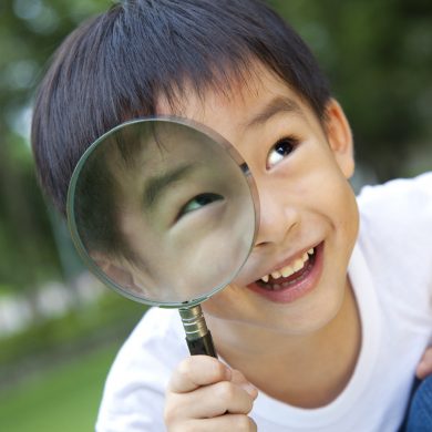 10776750 - asian boy holding magnifier